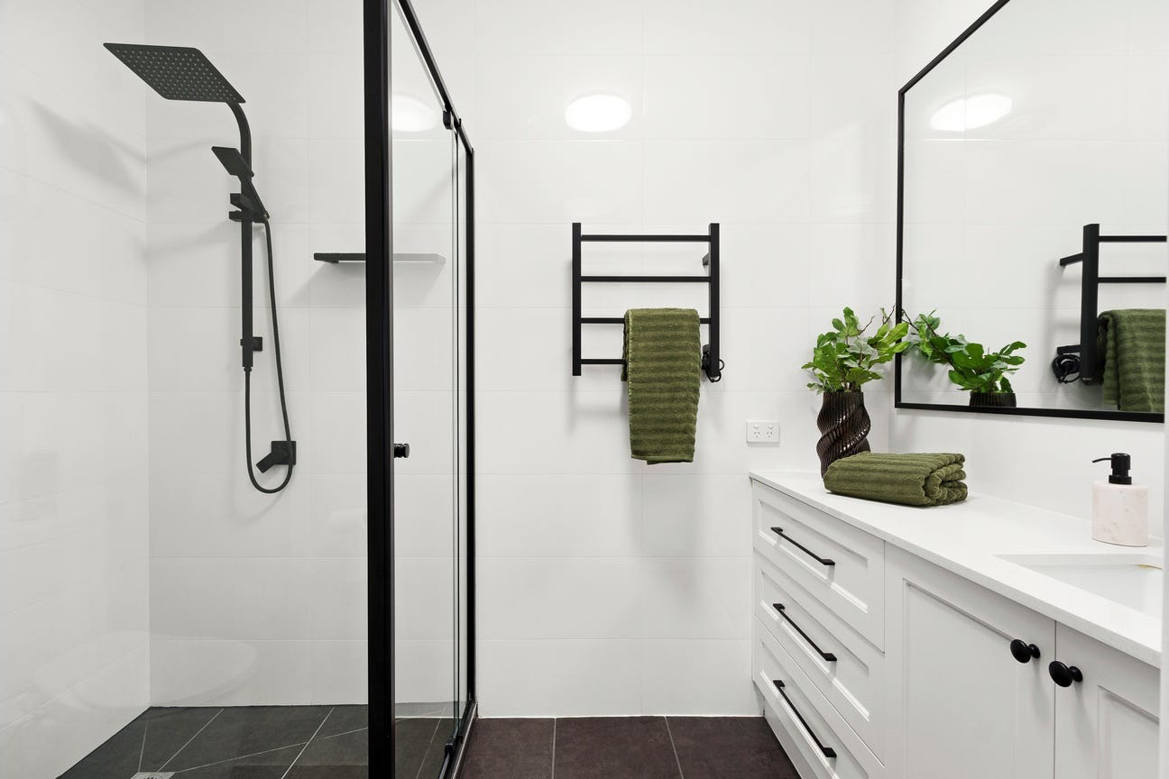 Renovated monochrome bathroom with black tapware and walk-in shower, Glenroy
