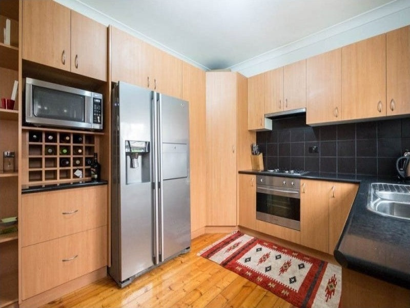 Original timber-look kitchen before renovation, Glenroy